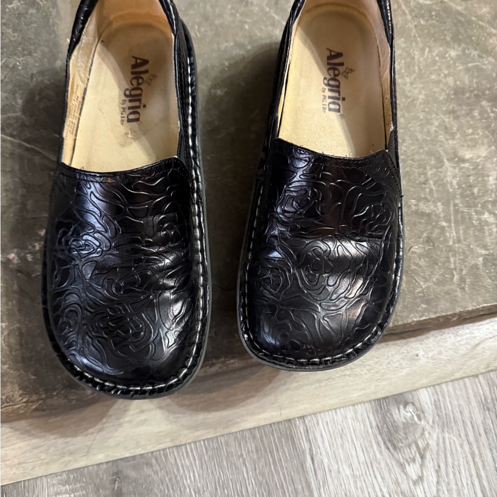 Alegria Black Embossed Slip-On Shoes